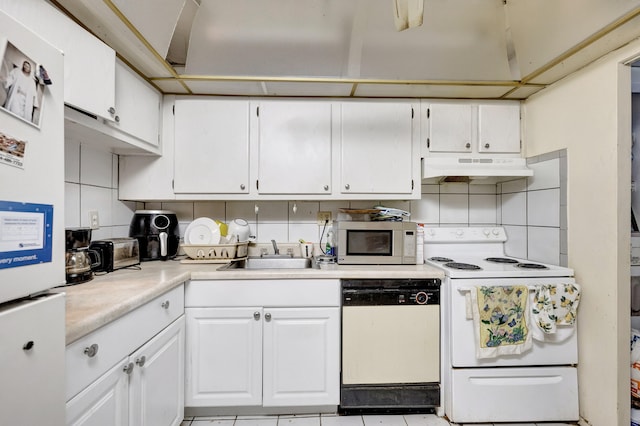 kitchen with white cabinetry, custom range hood, white appliances, light tile patterned floors, and decorative backsplash