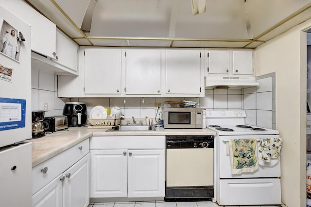 kitchen featuring white appliances, white cabinets, light countertops, and under cabinet range hood