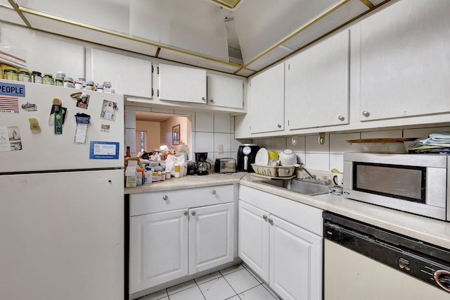 kitchen featuring tasteful backsplash, white appliances, white cabinets, sink, and light tile patterned flooring