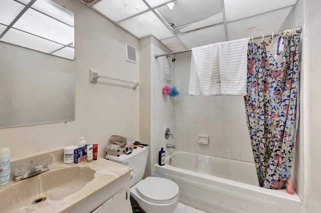 full bathroom with shower / tub combo with curtain, vanity, a paneled ceiling, toilet, and tile patterned flooring