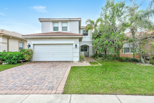 mediterranean / spanish-style home with a front yard and a garage