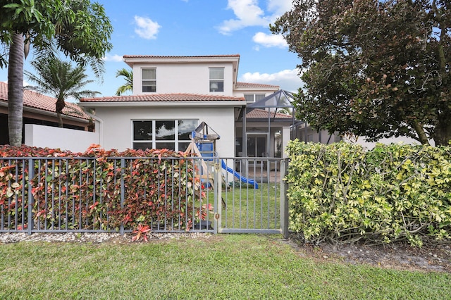 view of front of house with a playground and a front lawn