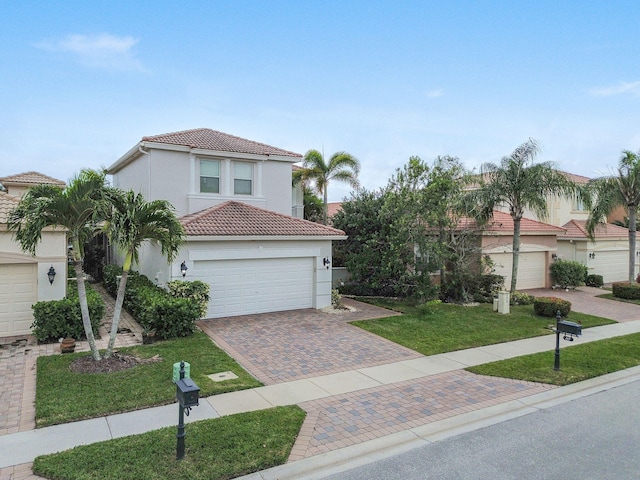 mediterranean / spanish-style home featuring a front yard and a garage