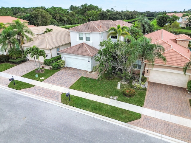 mediterranean / spanish home with a front yard and a garage