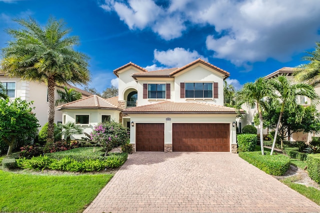 mediterranean / spanish-style home with a garage