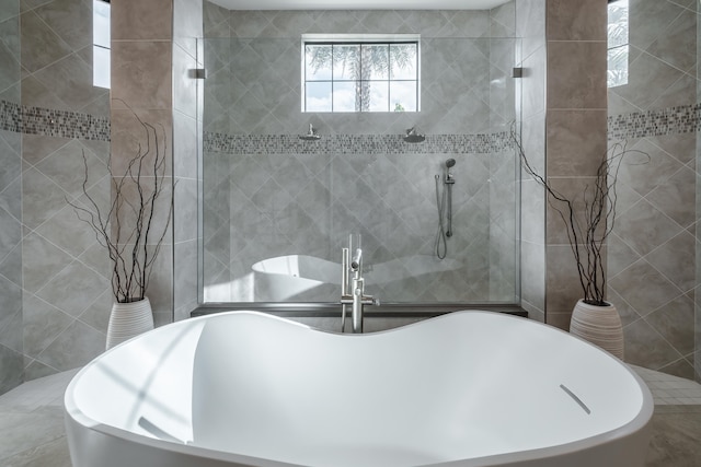 bathroom with a washtub and tile walls