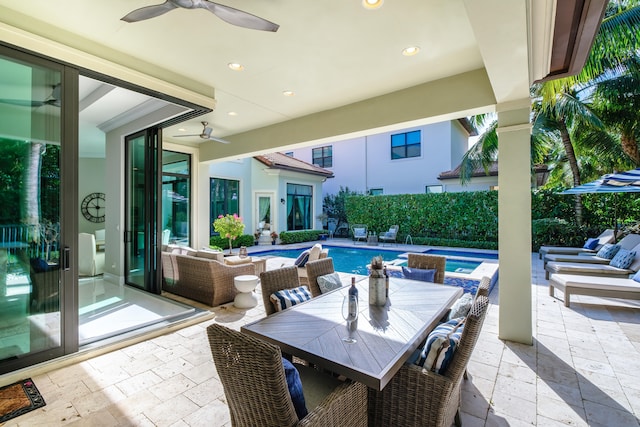 view of patio / terrace featuring ceiling fan, a fenced in pool, and an outdoor hangout area