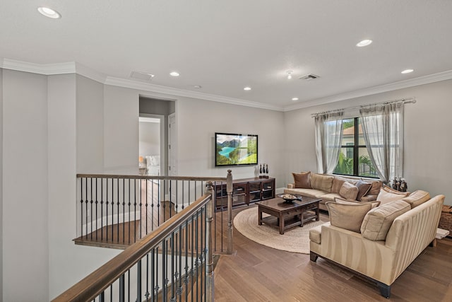 living room with dark wood-type flooring and ornamental molding