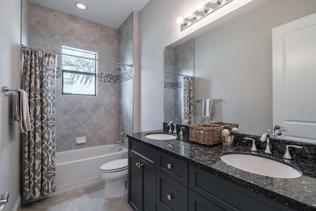 full bathroom featuring shower / bathtub combination with curtain, toilet, dual bowl vanity, and tile patterned flooring