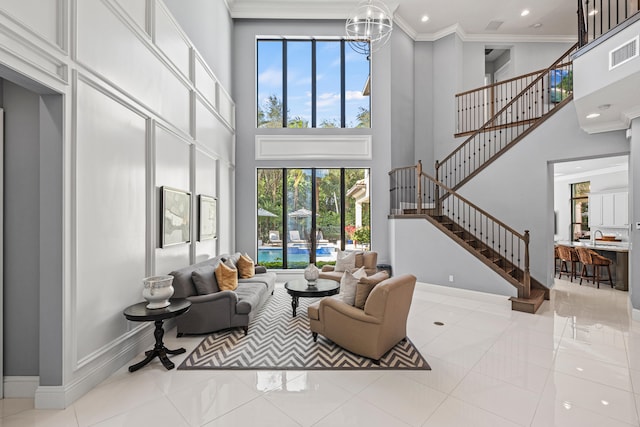 living room with light tile patterned flooring, a towering ceiling, and crown molding