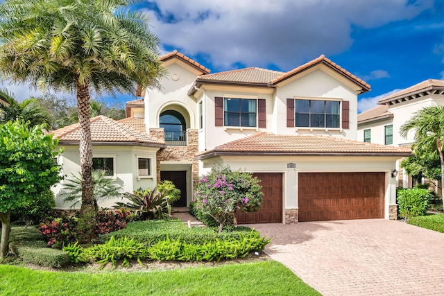 mediterranean / spanish-style home featuring a garage