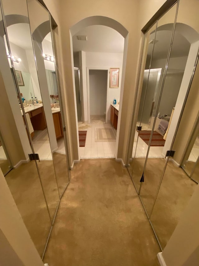 hall featuring light tile patterned flooring