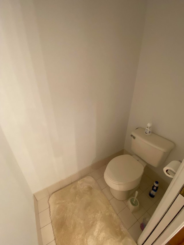 bathroom with toilet and tile patterned floors