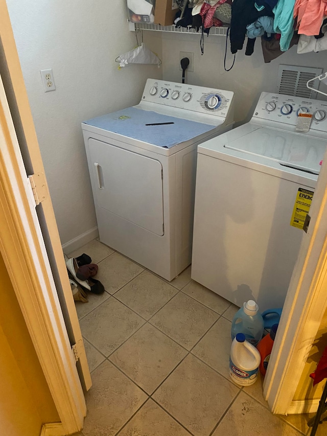 interior space with tile walls, stacked washer and clothes dryer, and tile patterned floors