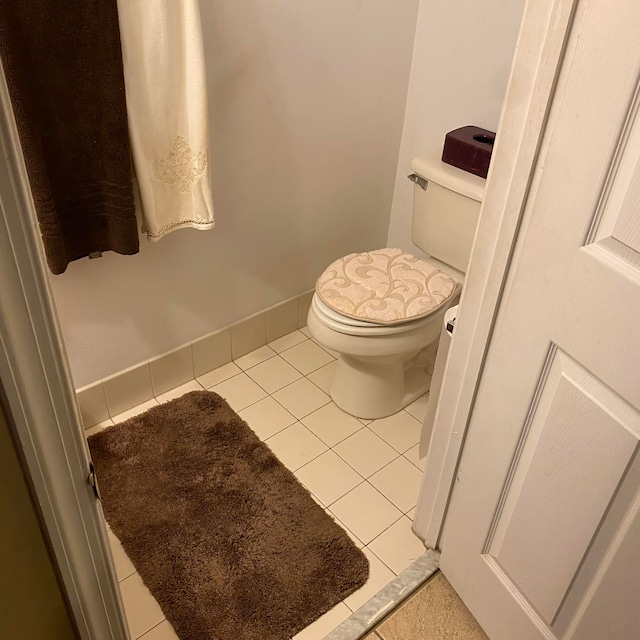 bathroom with toilet and tile patterned floors