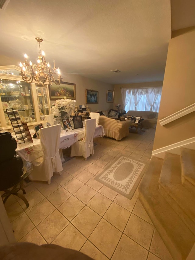 unfurnished living room with an inviting chandelier and light tile patterned floors