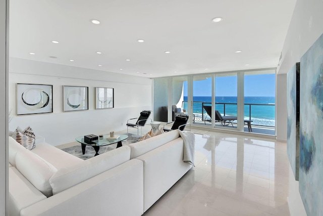 tiled living room with floor to ceiling windows and a water view