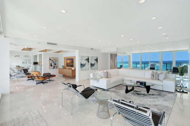 living room featuring expansive windows and a water view