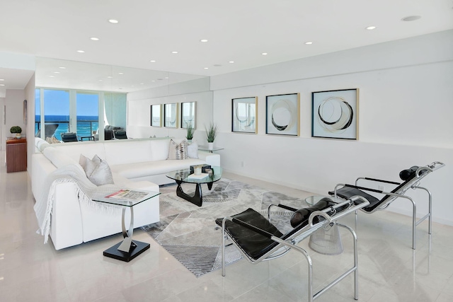 living room with french doors and a water view