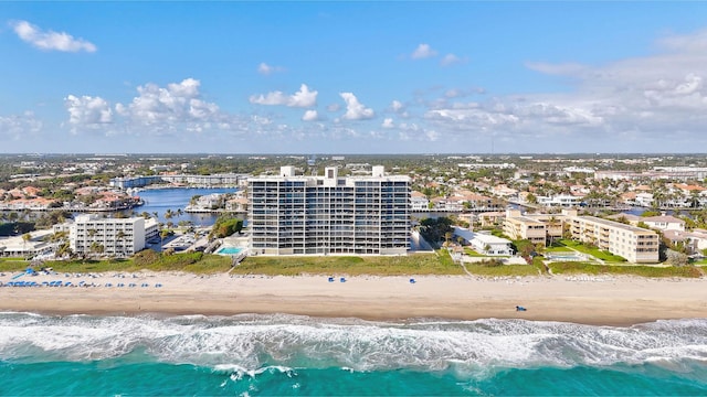 birds eye view of property with a beach view and a water view