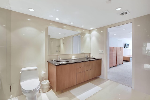 bathroom featuring a shower, vanity, and toilet