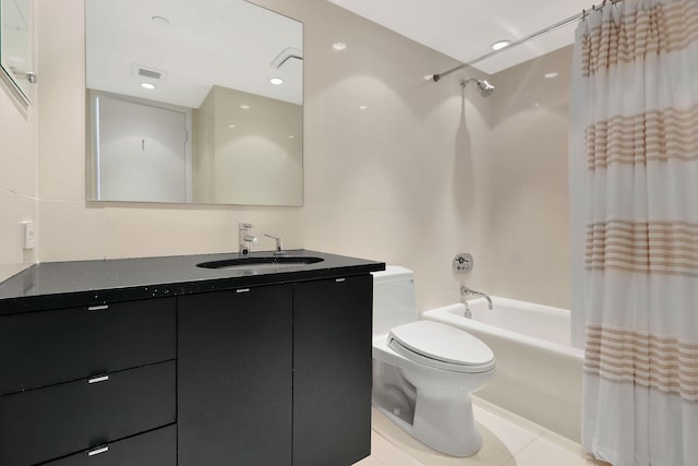 full bathroom with shower / bath combo, vanity, tile patterned floors, toilet, and tile walls