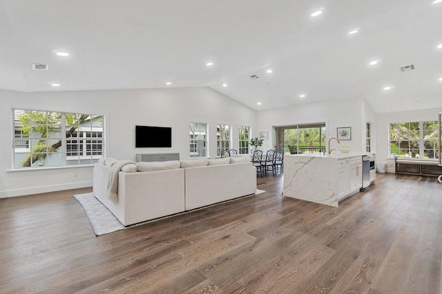 living room with high vaulted ceiling and hardwood / wood-style flooring