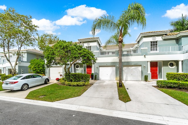 multi unit property featuring a balcony and a garage