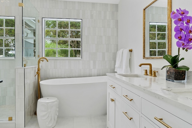 bathroom with tile walls, tile patterned flooring, and a wealth of natural light