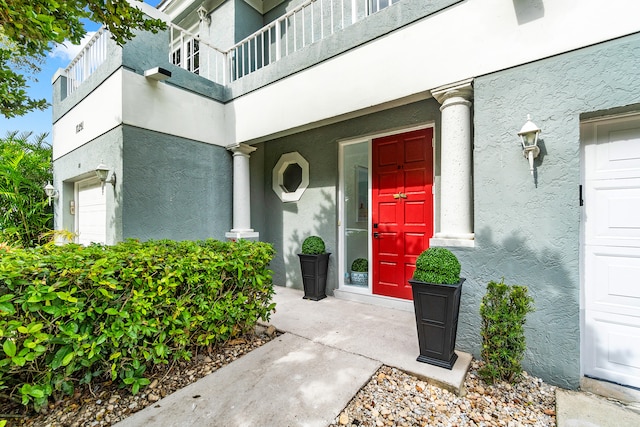 doorway to property featuring a balcony and a garage