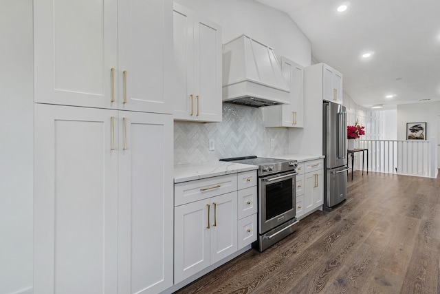 kitchen featuring dark hardwood / wood-style flooring, stainless steel appliances, light stone countertops, premium range hood, and white cabinets