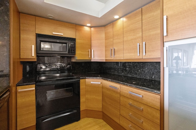 kitchen with tasteful backsplash, light hardwood / wood-style flooring, dark stone countertops, and black appliances