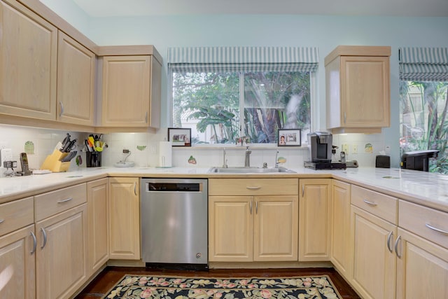 kitchen featuring sink, stainless steel dishwasher, decorative backsplash, and light brown cabinets