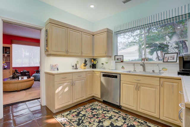 kitchen featuring sink, dishwasher, backsplash, and dark tile patterned floors