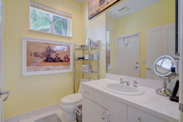 bathroom featuring vanity, tile patterned flooring, and toilet