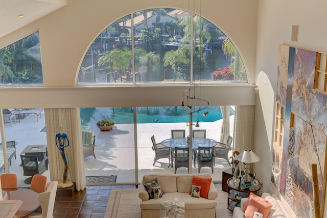 living room featuring tile patterned flooring and a towering ceiling