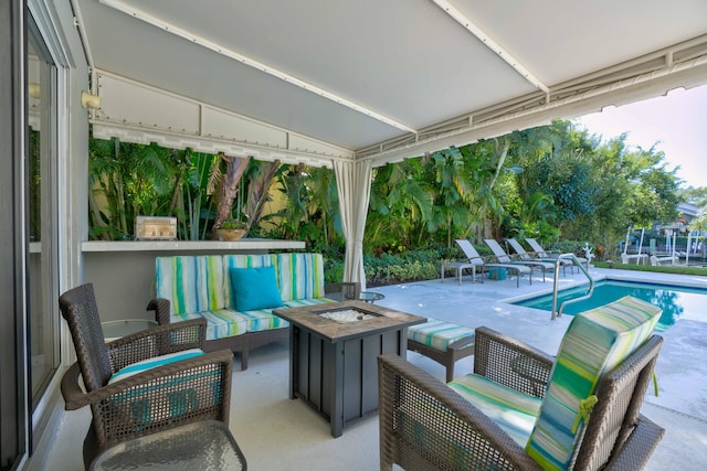 view of patio / terrace with an outdoor living space with a fire pit