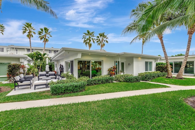 view of front of home with a front lawn and an outdoor living space