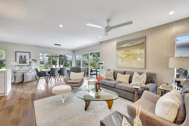 living room featuring ceiling fan and light wood-type flooring