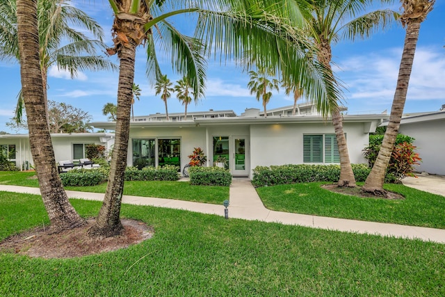 ranch-style home with a front lawn