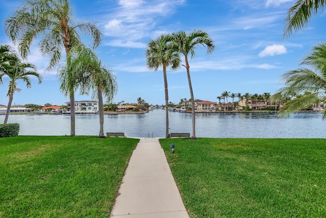 dock area featuring a lawn and a water view