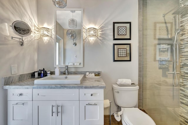 bathroom featuring toilet, an enclosed shower, and vanity