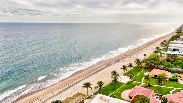 drone / aerial view with a beach view and a water view