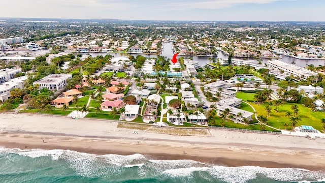 drone / aerial view featuring a beach view and a water view