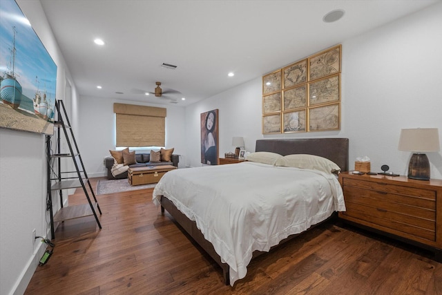 bedroom with dark hardwood / wood-style floors