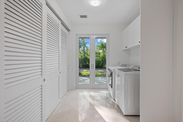 laundry room with french doors, washer and dryer, and cabinets