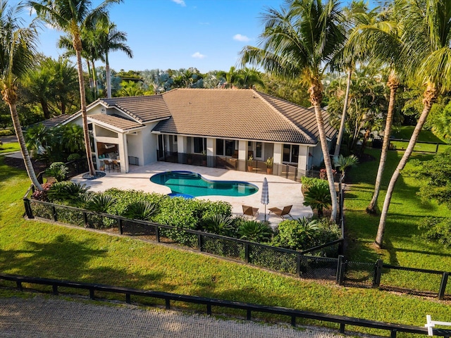 view of swimming pool featuring a patio and a yard