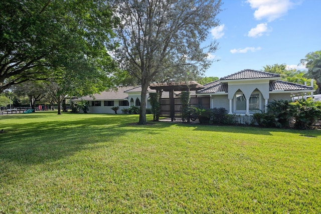 exterior space with a front yard and a pergola