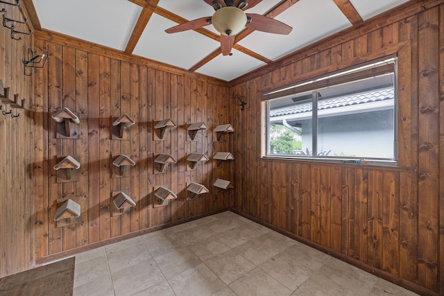 spare room with wooden walls, coffered ceiling, and ceiling fan