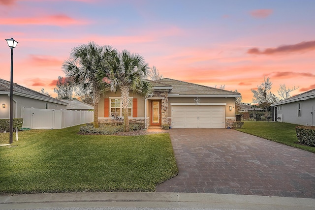 view of front of property featuring a yard and a garage